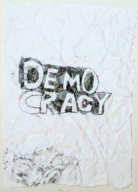 Gilbert van Drunen, ''Democracy'', 2009, potlood op papier, A4; het verfrummelde papier 'democracy' is weer ontvouwd, ingelijst. 9/10 UNICUM
PHŒBUS•Rotterdam