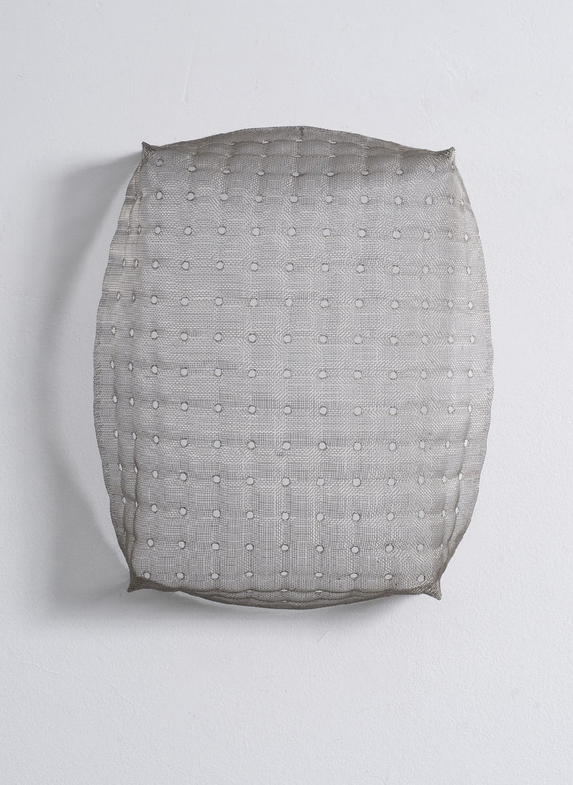 Hans Houwing, z.t. 1998, een aantal mazen op regelmatige afstanden opgerekt in een rechthoekig, half kussen van fijnmazig rvs-gaas, 35 x 29 x 13 cm.  No. 5 in boekuitgave.
PHŒBUS•Rotterdam